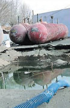 Photo by Jill Aho: Underground storage tanks used to hold fuel were unearthed at a former gas station