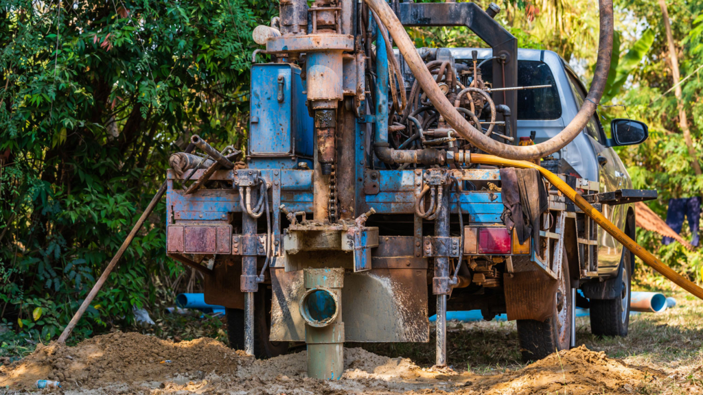 Ground drilling water machine on old truck drilling in the ground