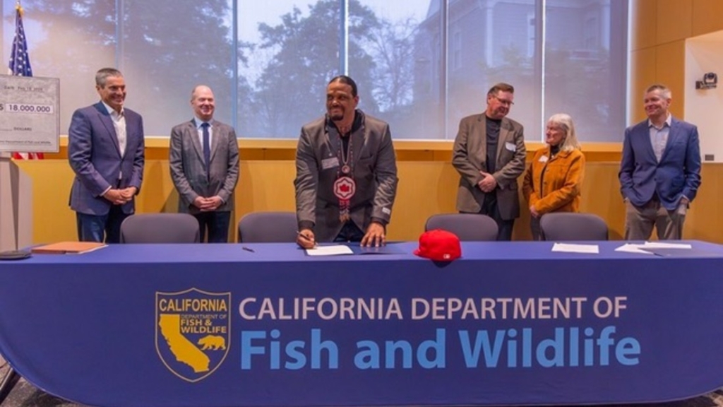 State officials, conservation groups watch Round Valley Indian Tribes President Joseph Parker sign an MOU